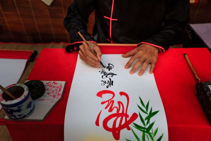 Older adult practicing traditional Chinese calligraphy