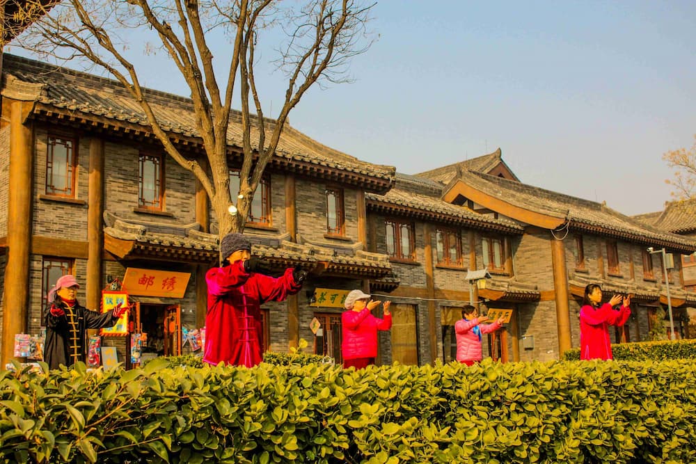 Seniors practicing Tai Chi together in a Chinese park